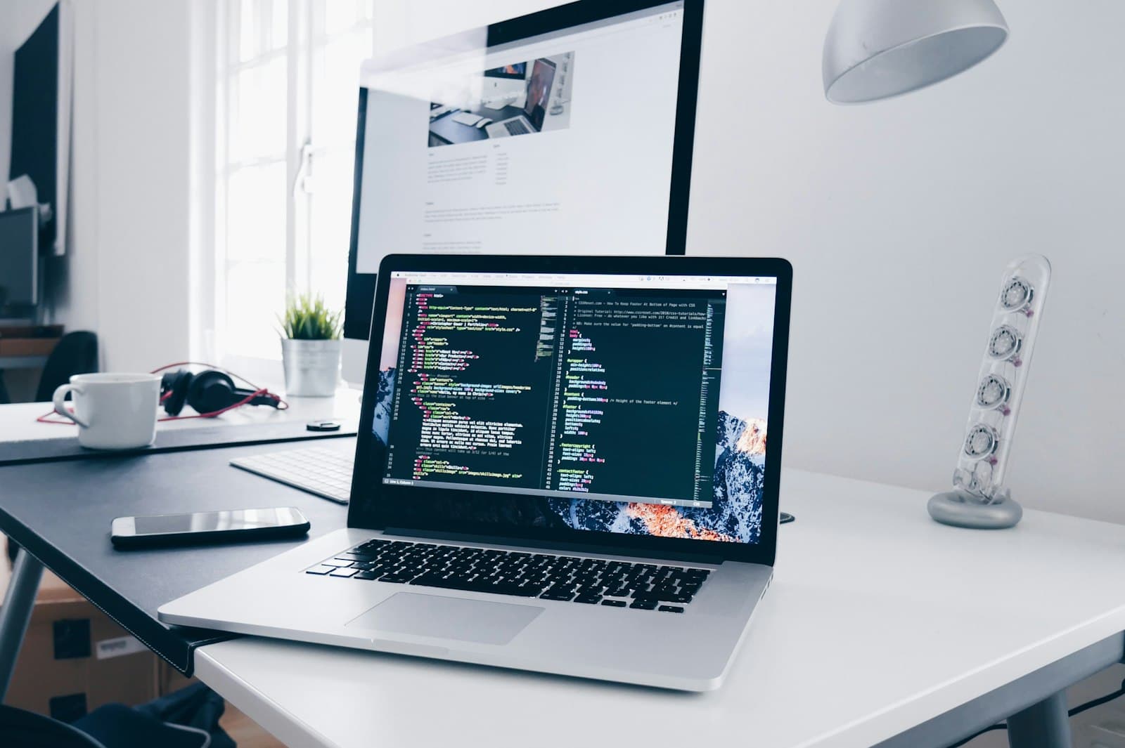 Laptop with application code open in a bright, minimal workspace.